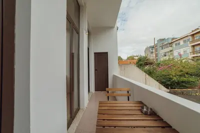a wooden stairway with a bench on the side of a building at Modern Bonfim by Hosty in Porto