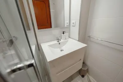 a white bathroom with a sink and a mirror at Bonfim Vintage by Hosty in Porto