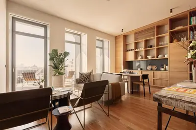 a kitchen and living room with a table and chairs at Vandoma Serviced Apartments in Porto