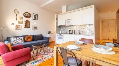 a living room with a table and a blue couch at Bolhão Charming Apartment by LovelyStay in Porto