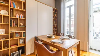 a wall with framed pictures and a mirror at Bolhão Charming Apartment by LovelyStay in Porto
