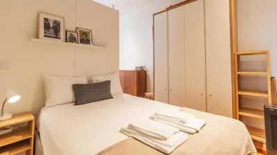 a bedroom with a bed with towels on it at Bolhão Charming Apartment by LovelyStay in Porto
