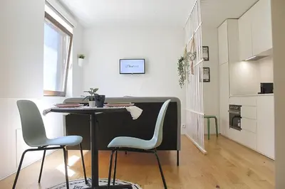 a kitchen with a table and chairs in a room at Classy Urban Life Studio Oporto in Porto