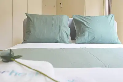 a bedroom with a bed with blue pillows at Classy Urban Life Studio Oporto in Porto