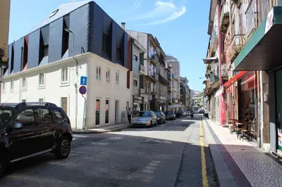 a city street with cars parked on the side of the road at Classy Urban Life Studio Oporto in Porto