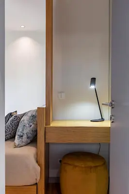 a bedroom with a bed with a mirror and a stool at Almada 505 - Premium Flat in Porto