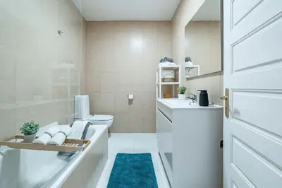 a bathroom with a toilet and a sink at Oliveira Monteiro Flat in Porto