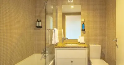 a bathroom with a sink and a toilet and a mirror at FLORES 36 by YoursPorto in Porto