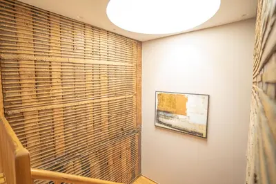 a room with wooden blinds on the wall and a painting at FLORES 36 by YoursPorto in Porto