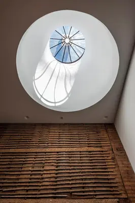 a round window in a room with a wooden floor at FLORES 36 by YoursPorto in Porto