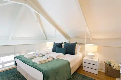a bedroom with a bed with towels on it at BOUTiQUE Rentals- LOvPORTO Ribeira historic center in Porto