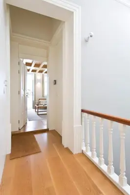 a hallway with white walls and a wooden floor at BOUTiQUE Rentals- LOvPORTO Ribeira historic center in Porto