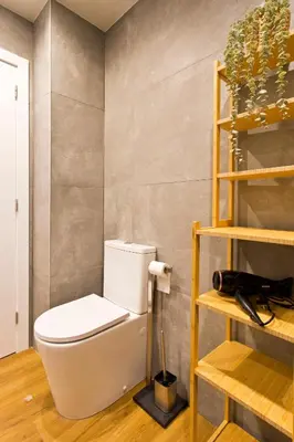 a bathroom with a white toilet in a room at Aposentus - Sofia's House in Porto