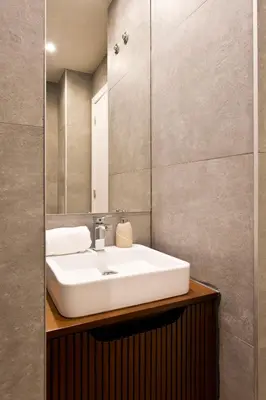 a bathroom with a white sink and a mirror at Aposentus - Sofia's House in Porto