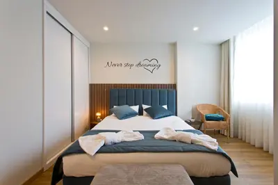 a bedroom with a large bed with towels on it at Aposentus - Sofia's House in Porto