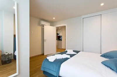 a bedroom with a large bed with towels on it at Aposentus - Sofia's House in Porto