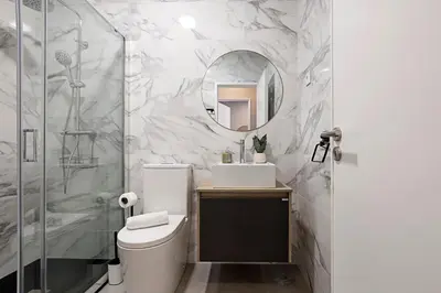 a bathroom with a toilet and a sink and a mirror at Lovely Flat Marquês in Porto