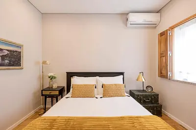 a bedroom with a large white bed and a window at Lovely Flat Marquês in Porto