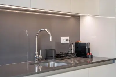 a kitchen counter with a sink and a coffee maker at Gaia Retreat by LovelyStay in Vila Nova de Gaia