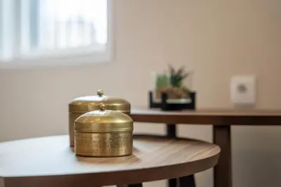 two gold containers sitting on a wooden table at Gaia Retreat by LovelyStay in Vila Nova de Gaia