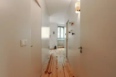 a hallway with a wooden floor and white walls at Cristelo 1 Bed next to River in Porto