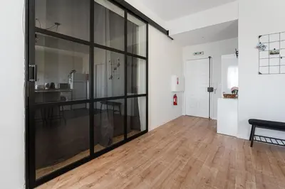 a room with glass doors and a wooden floor at Catarina's Little Corner by LovelyStay in Porto