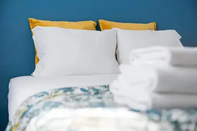 a bed with white sheets and pillows at Catarina's Little Corner by LovelyStay in Porto