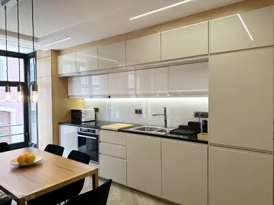 a kitchen with white cabinets and a wooden table at ROSARIO 1E by rosario inn porto in Porto