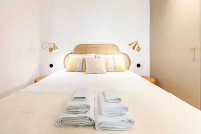 a bedroom with a bed with towels on it at Perfect retreat in the center of Porto in Porto