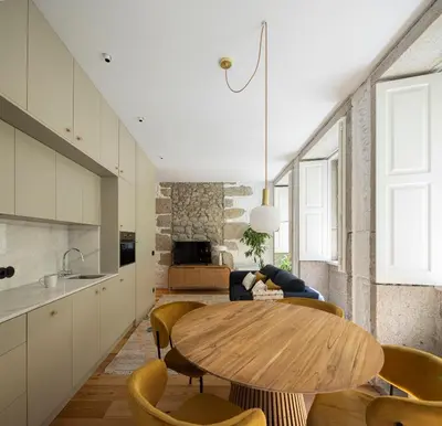 a kitchen and dining room with a wooden table and chairs at Elegant apartment in the historical center of Porto in Porto