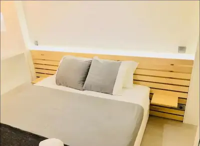 a white bed with two pillows on top of it at Cozy Studio city center in Porto
