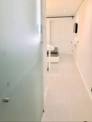 a white room with a bed and a door at Cozy Studio city center in Porto