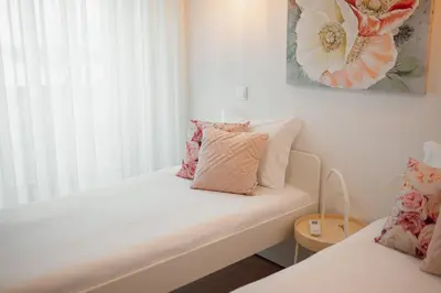 a room with two beds and a window at City Center Grand Apartment With Seaview Terrace by Vacationy in Porto