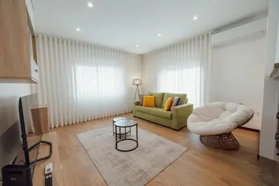 a living room with a couch and a chair at City Center Grand Apartment With Seaview Terrace by Vacationy in Porto