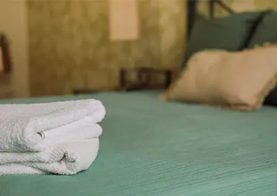 a pile of towels sitting on top of a bed at D João IV Stay in Porto