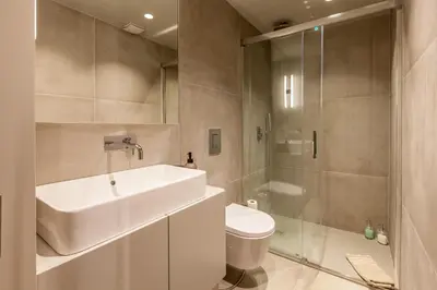 a bathroom with a sink and a toilet and a shower at Sta. Catarina 618 Suite in Porto
