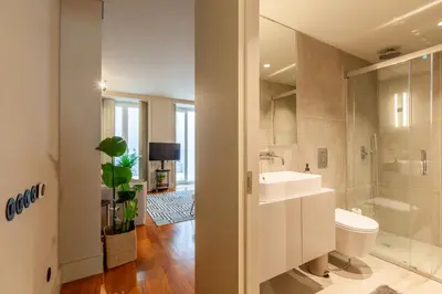 a bathroom with a sink and a shower and a toilet at Sta. Catarina 618 Suite in Porto
