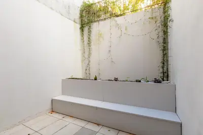 a bathroom with a window with ivy on the wall at Sta. Catarina 618 Suite in Porto