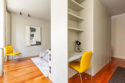 a home office with yellow chairs and a desk at Sta. Catarina 618 Suite in Porto