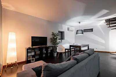 a living room with a couch and a table at Panoramic River View Downtown With Terrace in Porto