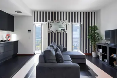 a living room with a couch and a television at Panoramic River View Downtown With Terrace in Porto
