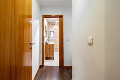a hallway with a door leading to a bathroom at Panoramic River View Downtown With Terrace in Porto