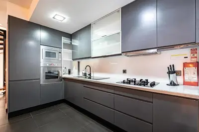 a kitchen with stainless steel appliances and gray cabinets at Panoramic River View Downtown With Terrace in Porto
