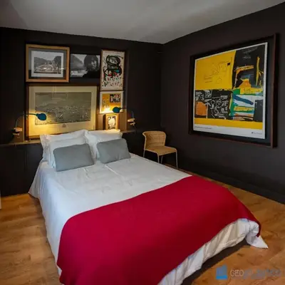 a bedroom with a large bed with a red blanket at Y Trendy Arthouse Boavista in Porto