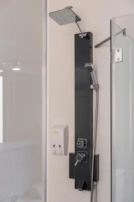 a bathroom with a shower with a glass door at Apartamentos Portodouro - Ribeira in Porto