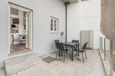 a patio with a table and chairs and a dining room at GuestReady - Riverview Douro Terrace in Vila Nova de Gaia