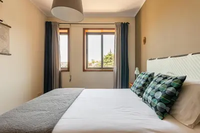 a bedroom with a bed and a window at Lázaro 2 Bedroom Apartment in Porto