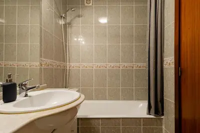 a bathroom with a sink and a shower at Lázaro 2 Bedroom Apartment in Porto