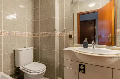a bathroom with a toilet and a sink at Lázaro 2 Bedroom Apartment in Porto
