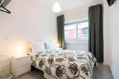 a bedroom with a bed and a window at Moreira Family in Porto